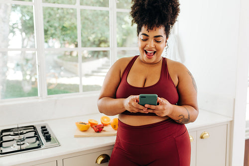 Body positive woman messaging on smart phone