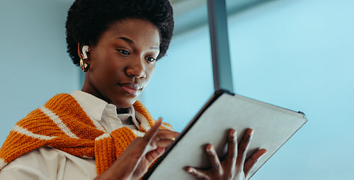 Confident black businesswoman using tablet