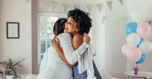 Pregnant woman hugging a friend at baby shower