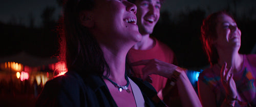Woman dancing with friends on a festival dance floor