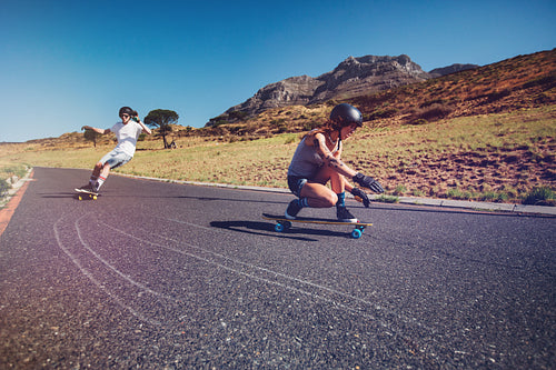 Young people practicing long board riding