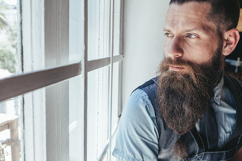 Hairdresser looking away and thinking 