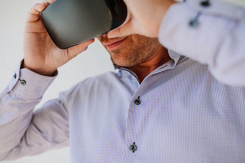 Young man using Virtual Reality glasses
