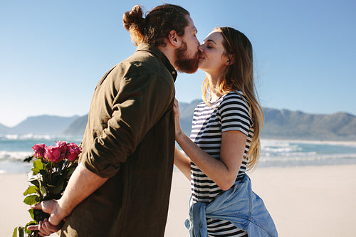 Loving couple kissing on the beach