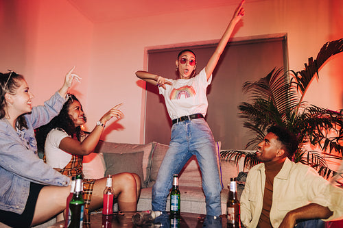 Vibrant young woman dancing for her friends at a party