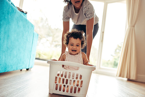 Baby enjoying at home with mother