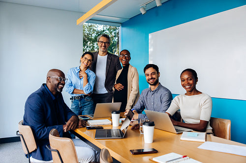 Diverse group of professionals smiling during a meeting in an office setting