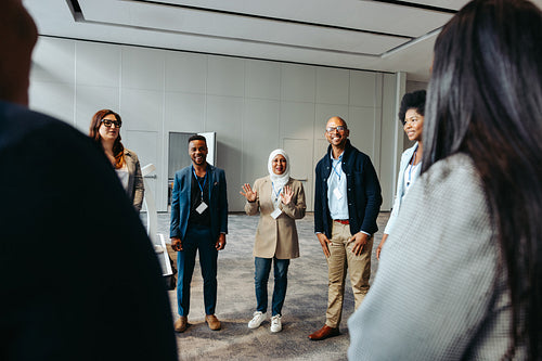 Diverse team talking and teambuilding in an office setting