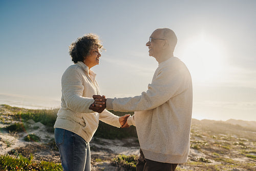 Senior couple dancing happily at the beach