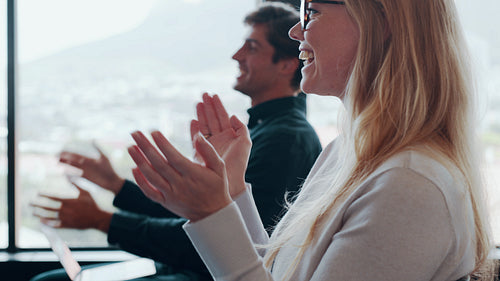Audience clapping hands at a seminar