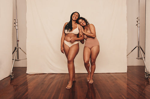 Young women embracing their natural bodies in a studio