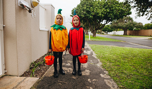 Twin sisters trick-or-treating on Halloween