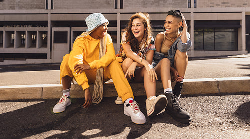 Three best friends sitting together outdoors