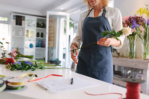 Skillful woman making bouquet in workshop