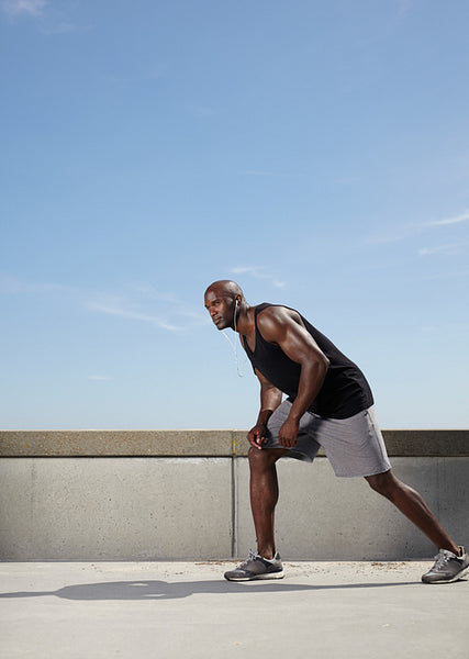 Guy gets ready to run outdoors
