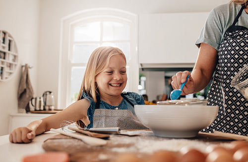 Mother and daughter baking in kitchen