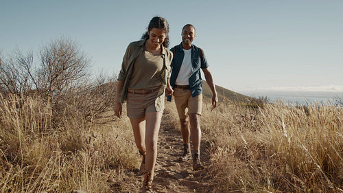 Couple trekking together on a mountain trail