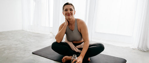 Seated yoga and meditation bring the woman into a mindful home routine