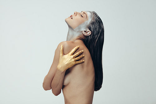 Sensual woman with silver and gold body paint