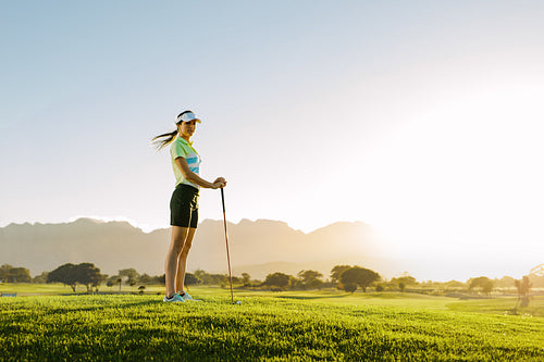 Female golfer standing on golf course