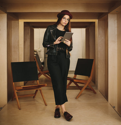 Portrait of a businesswoman standing in office holding digital tablet