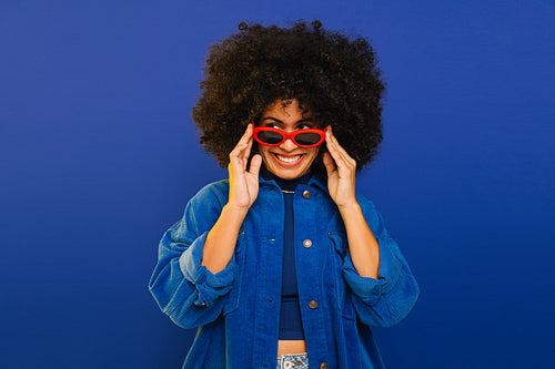 Happy young woman looking away while wearing sunglasses