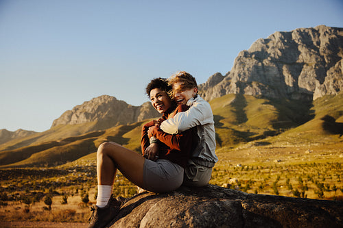 Couple sitting together on a rock