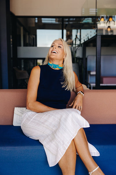 Smiling woman sitting in a modern interior enjoying a happy moment