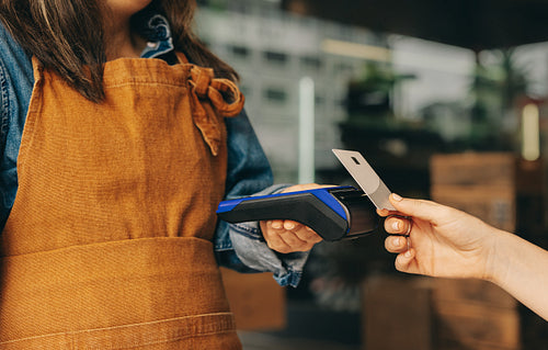 Customer paying her bill using a credit card