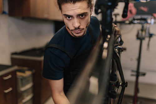 Mechanic repairing a bicycle in workshop