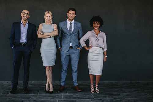 Successful business team standing together and smiling