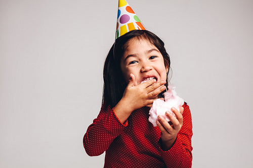 Close up of a kid enjoying candy floss