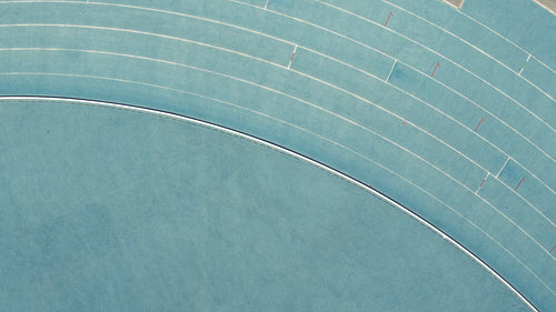 Sprinter running on athletic race track in stadium