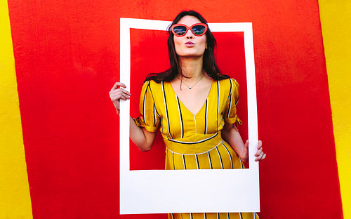 Attractive girl posing with photo frame