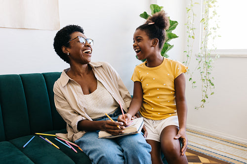 Mom and daughter have fun with a colouring activity