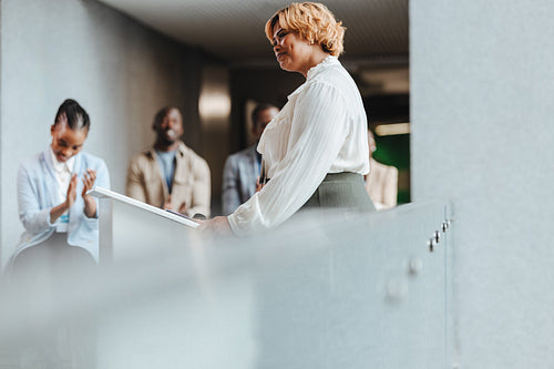 Confident businesswoman receiving an applause in office environment