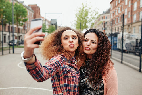 Beautiful pouting women taking a selfie