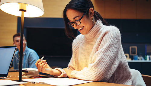 Happy young student in high school library