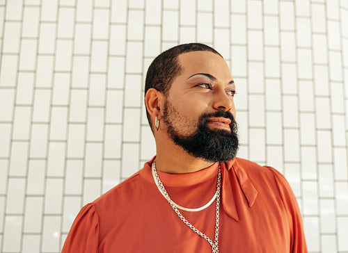 Young man looking thoughtful while wearing drag