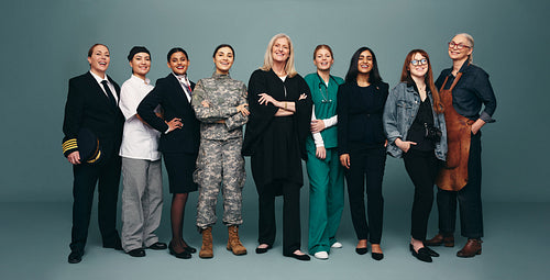 Cheerful female workers standing together in a studio