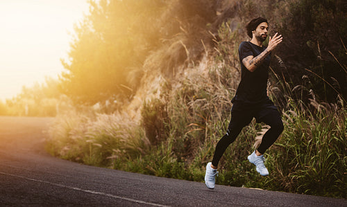 Man running fast on mountain road