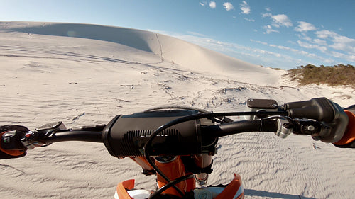 Cross country athlete racing over sand dunes