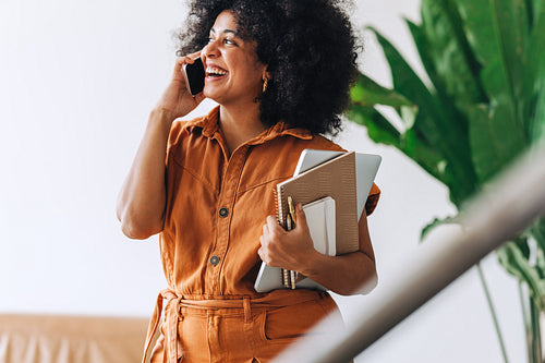Cheerful businesswoman taking a phone call in an office