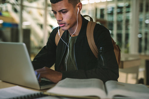 Student preparing school assignment in library