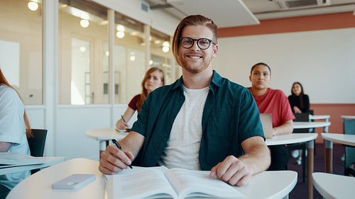Smiling student in high school classroom