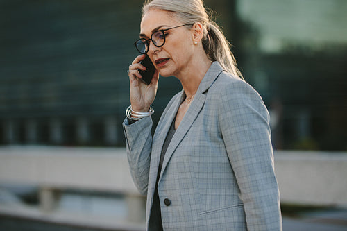 Senior businesswoman talking on cellphone in the city