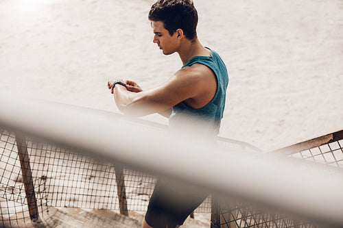 Runner using smart watch to monitor his progress