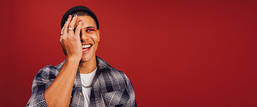 Non-conforming young man wearing nail polish and makeup in a stu