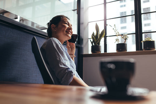 Businesswoman talking on mobile phone in office