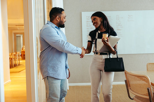 Business professionals exchanging a farewell handshake after a client meeting